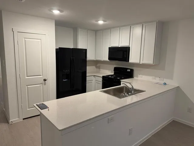 a kitchen with a refrigerator and a sink