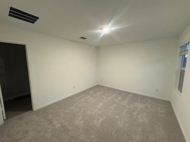 an empty room with a empty space and a window