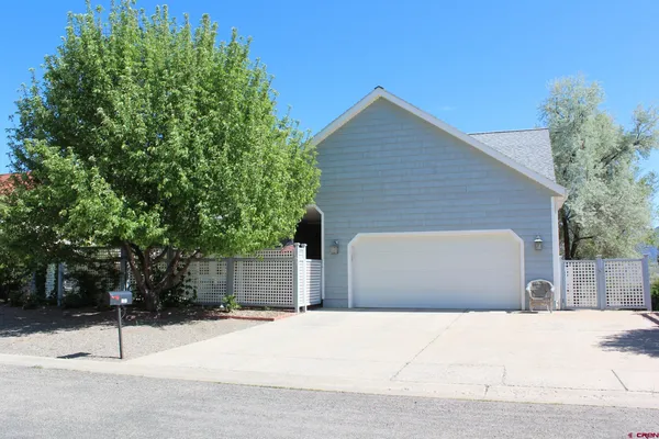 a view of a house with a yard and garage