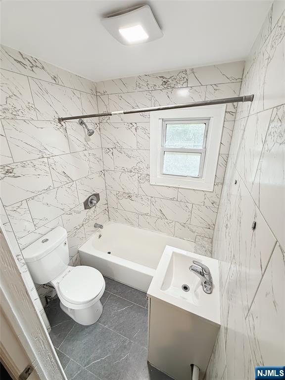 339 Howe Avenue, Unit 1 Passaic, NJ 07055 - Photo 12 of 23 a bathroom with a bathtub a sink a toilet and a shower