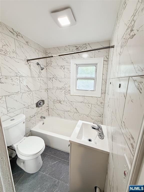339 Howe Avenue, Unit 1 Passaic, NJ 07055 - Photo 13 of 23 a bathroom with a sink a toilet and a bathtub