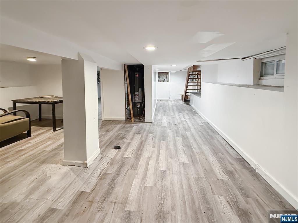 339 Howe Avenue, Unit 1 Passaic, NJ 07055 - Photo 15 of 23 a view of a hallway with wooden floor and furniture