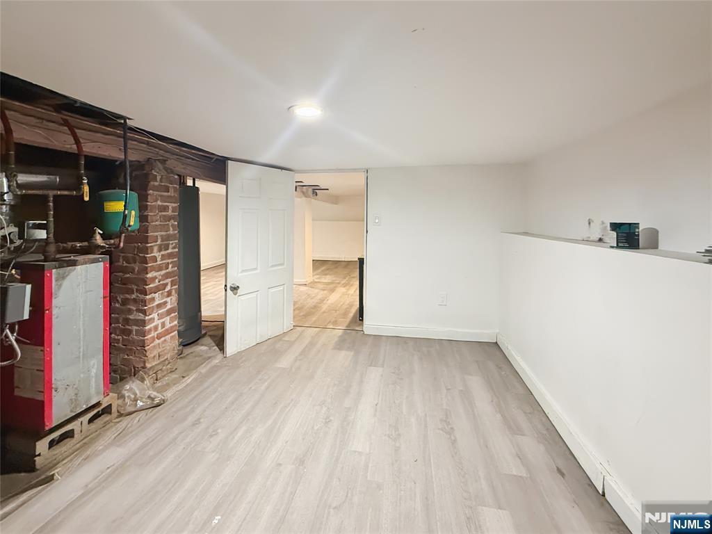 339 Howe Avenue, Unit 1 Passaic, NJ 07055 - Photo 20 of 23 a view of empty room with wooden floor and closet