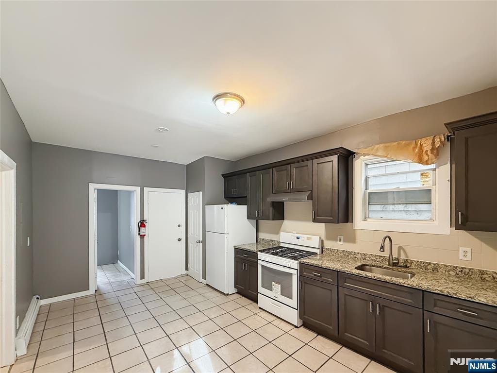 339 Howe Avenue, Unit 1 Passaic, NJ 07055 - Photo 2 of 23 a kitchen with refrigerator cabinets and a sink
