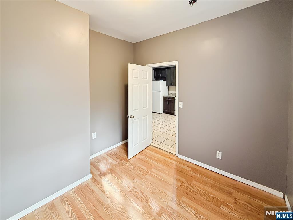 339 Howe Avenue, Unit 1 Passaic, NJ 07055 - Photo 7 of 23 a bedroom with a bed and a window