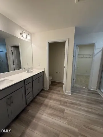 a view of empty room with wooden floor