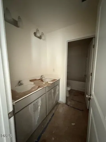 a view of a bedroom with a bed and a window