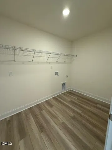 a view of a hallway to rooms and stairs