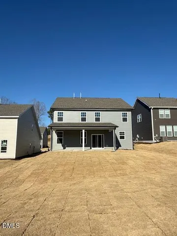 a view of a house with sitting area and swimming pool