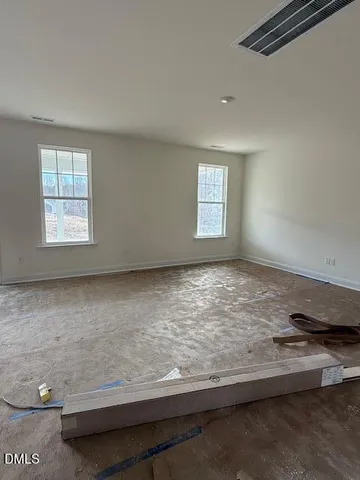 a view of wooden floor and window in a room