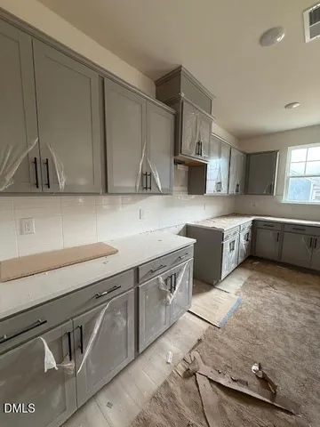 a kitchen with stainless steel appliances granite countertop a sink and a stove