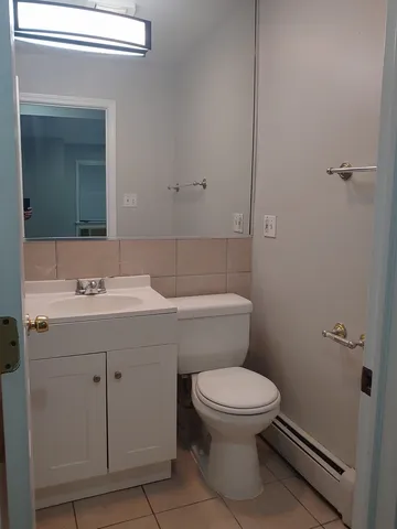 a bathroom with a sink a toilet and a mirror