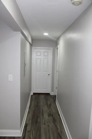 a view of hallway with wooden floor