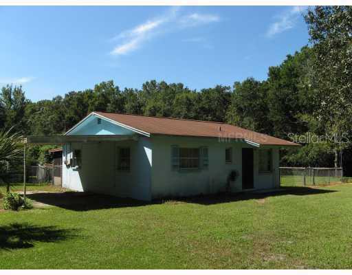 7458 Alafia Ridge Loop Riverview, FL 33569 - Photo 1 of 1 Exterior Front - Main House with Carport and Screened Patio