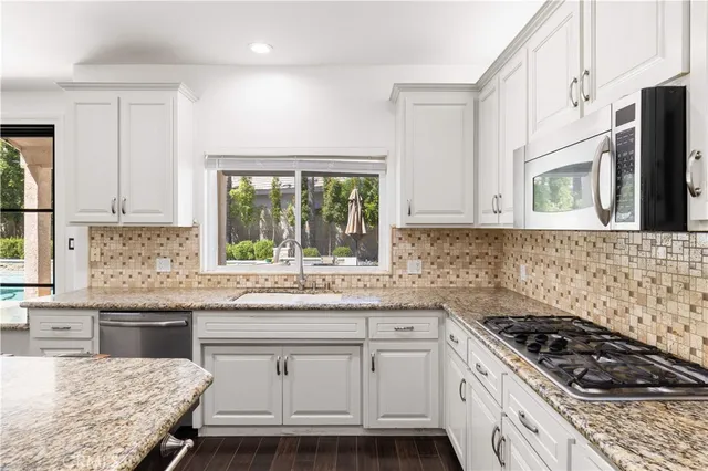 a living room with furniture a fireplace and a large window