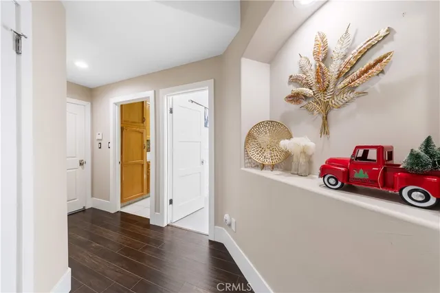 a very nice looking room with wooden floor and a bathroom