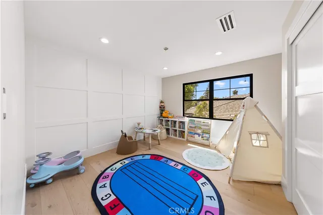 a spacious bedroom with a large bed and a flat screen tv