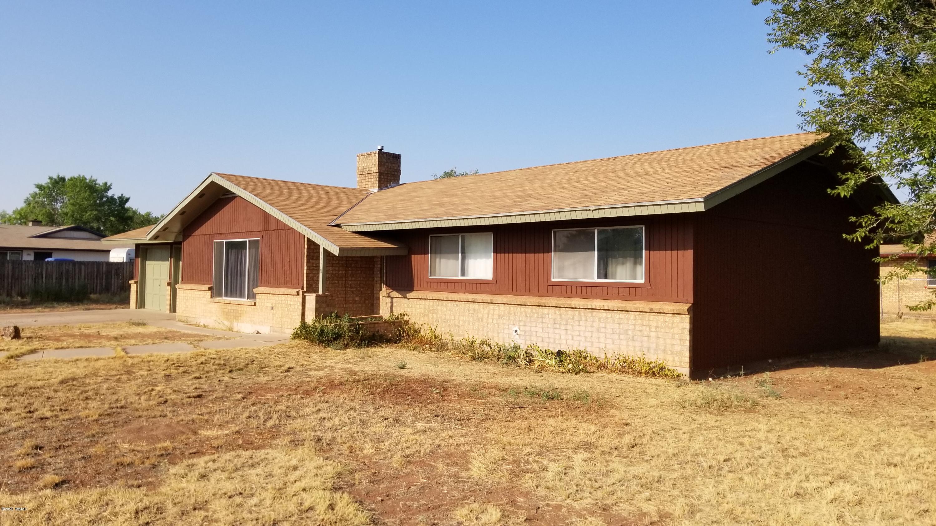 1110 7th West St. Johns, AZ 85936 - Photo 1 of 34 a front view of a house with a yard