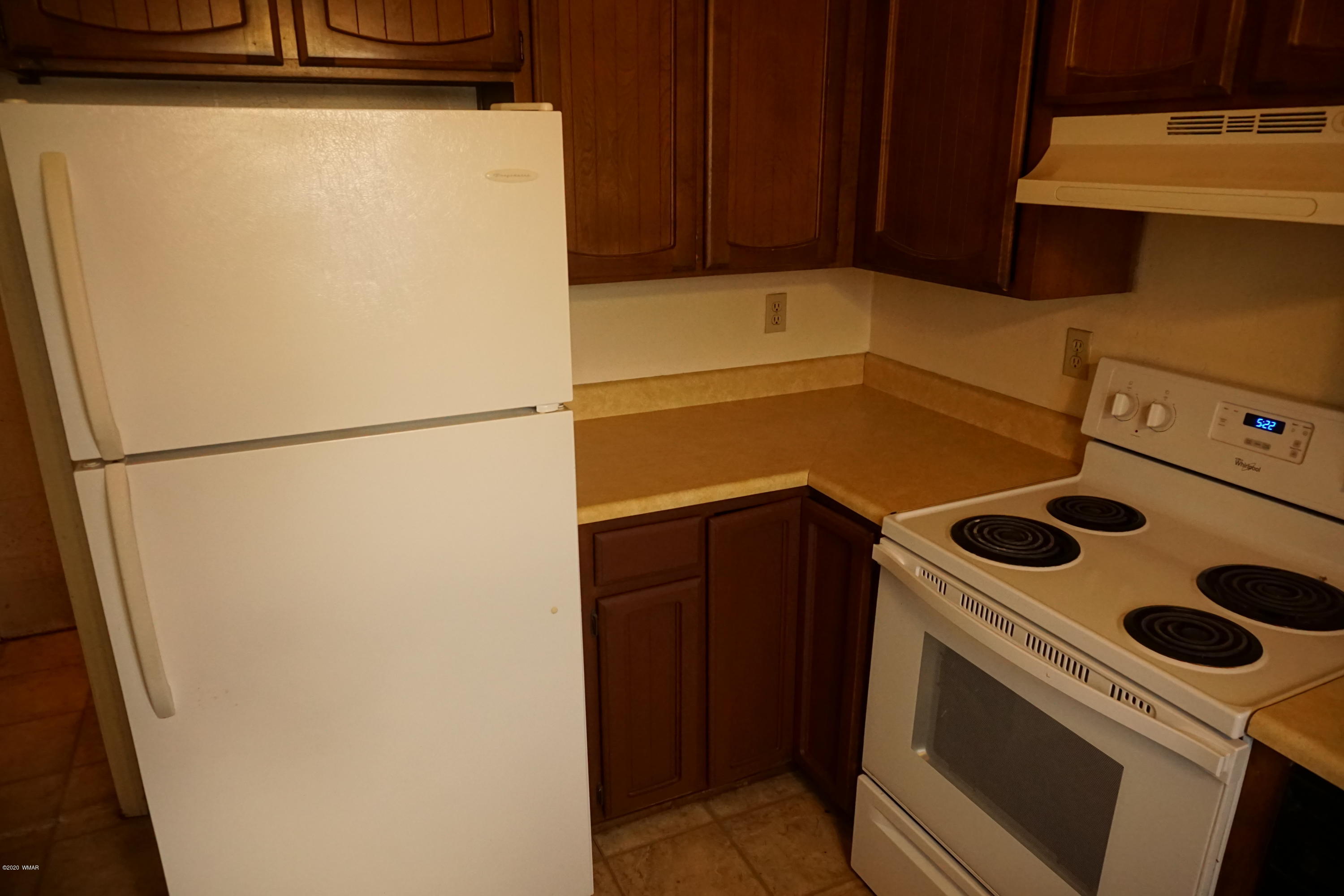 1110 7th West St. Johns, AZ 85936 - Photo 14 of 34 a white refrigerator freezer and a stove sitting inside of a kitchen