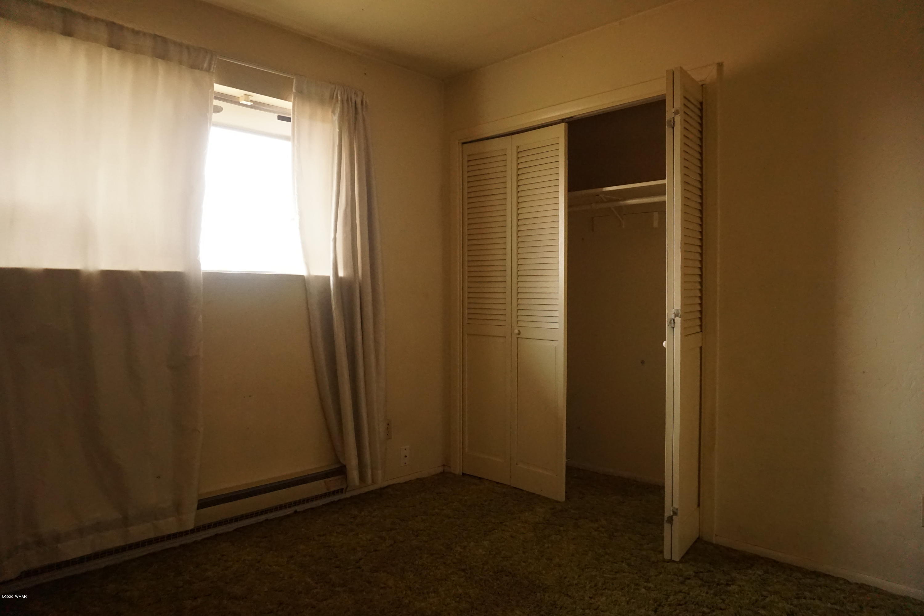 1110 7th West St. Johns, AZ 85936 - Photo 16 of 34 an empty room with windows and closet
