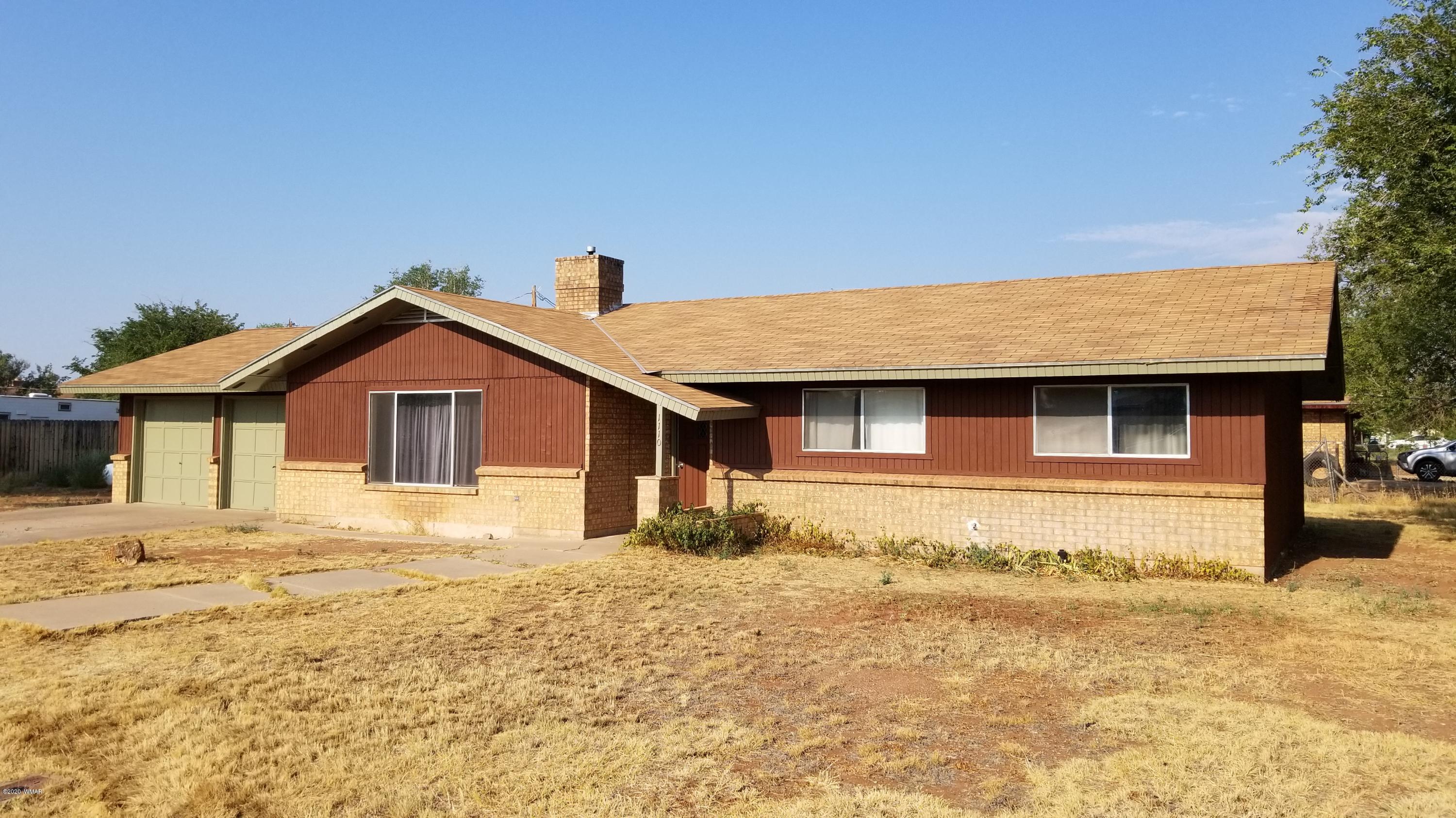1110 7th West St. Johns, AZ 85936 - Photo 2 of 34 a front view of a house with a yard