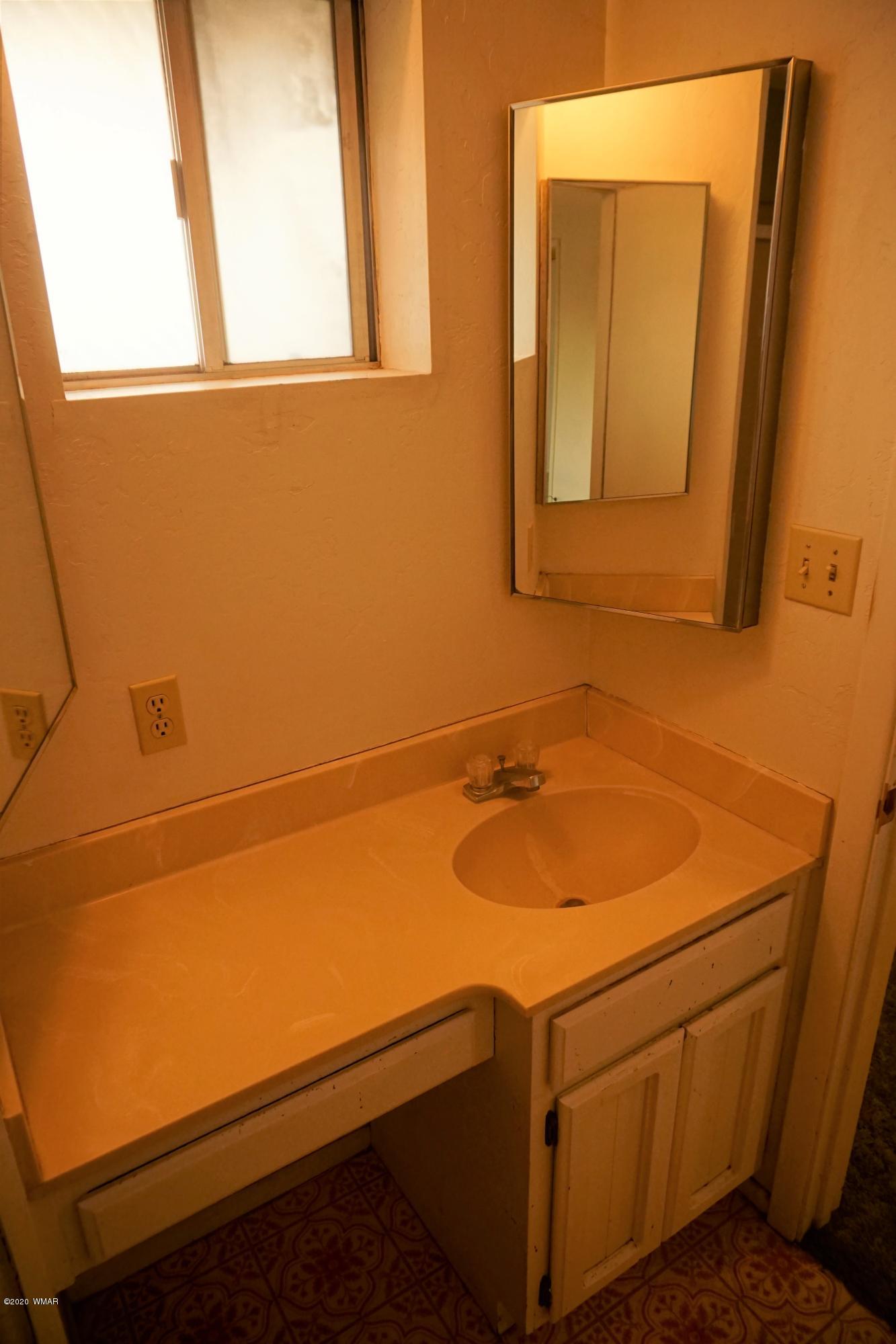 1110 7th West St. Johns, AZ 85936 - Photo 27 of 34 a bathroom with a sink and a mirror