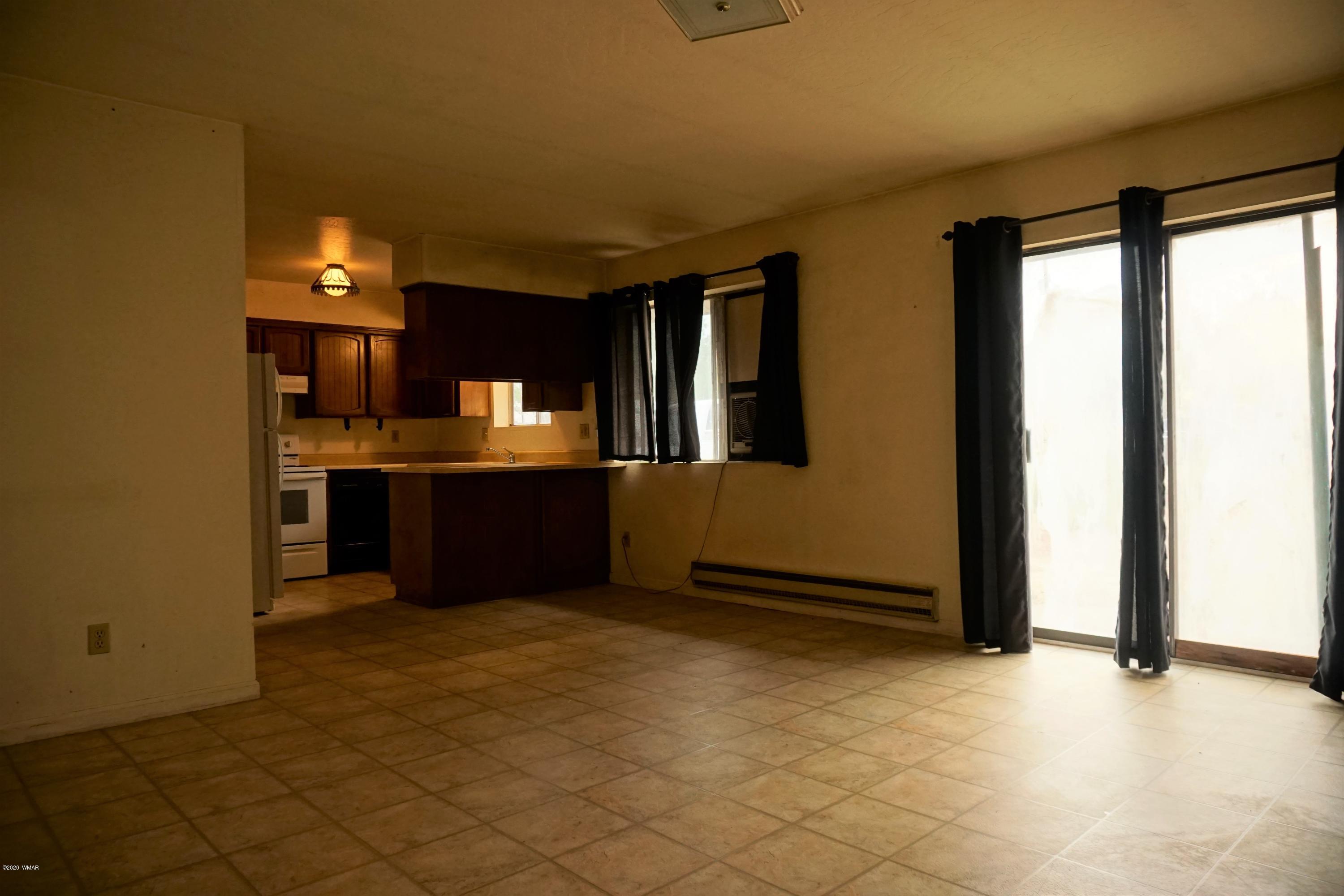1110 7th West St. Johns, AZ 85936 - Photo 7 of 34 an empty room with a kitchen