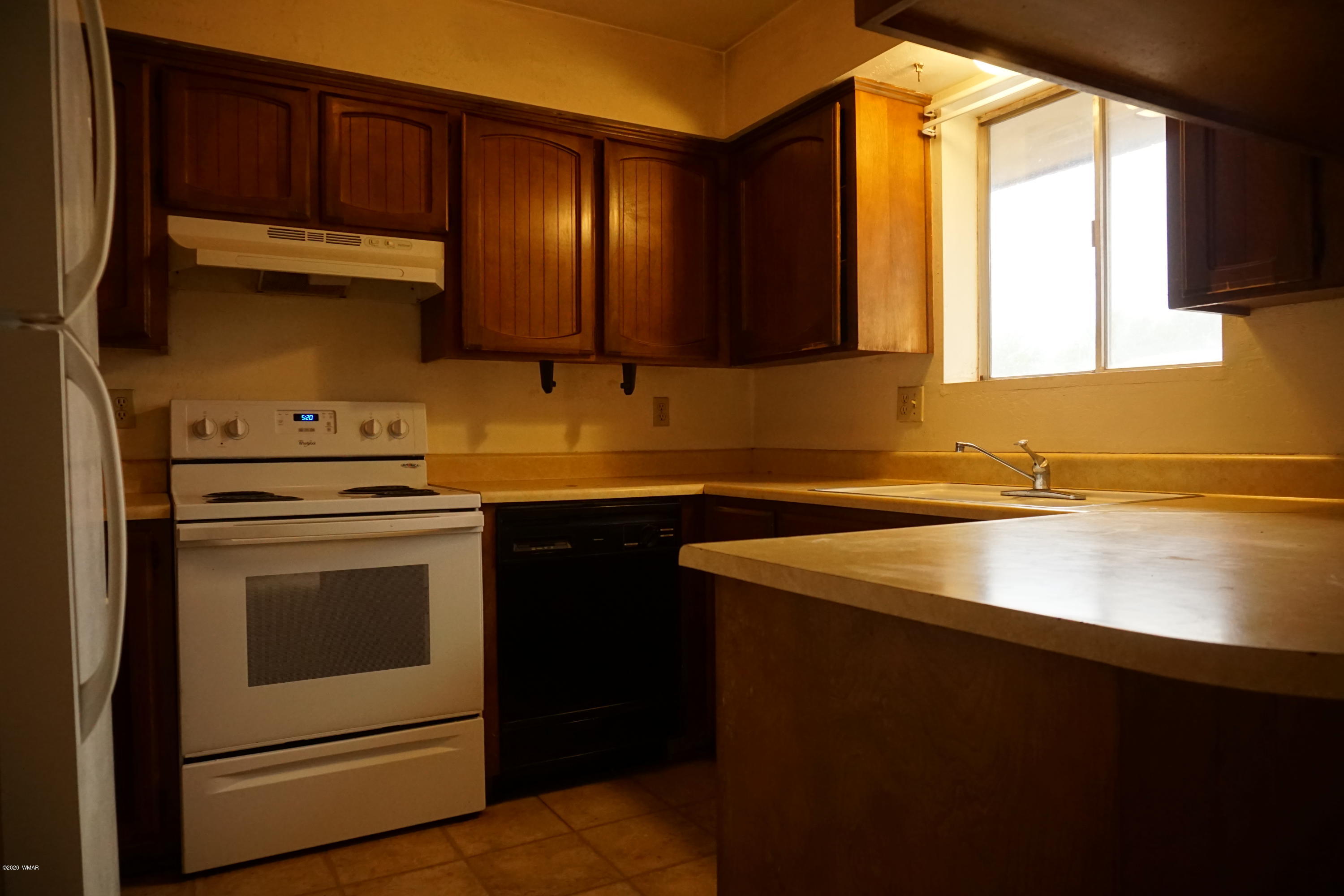 1110 7th West St. Johns, AZ 85936 - Photo 9 of 34 a kitchen with a sink cabinets and window