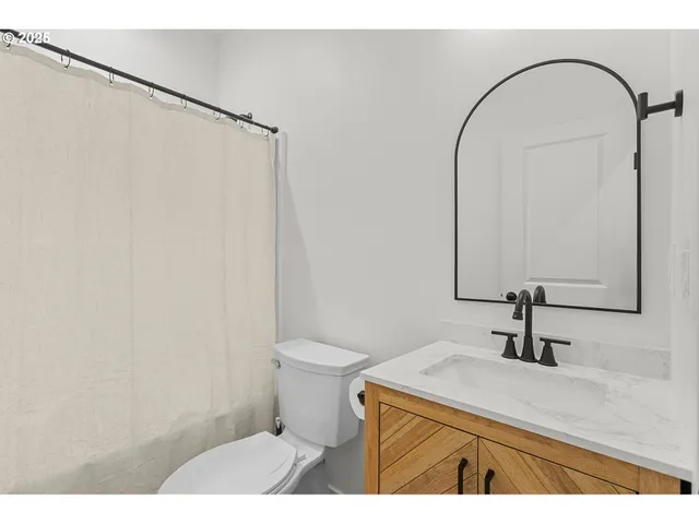 a spacious bedroom with a bed and a large window