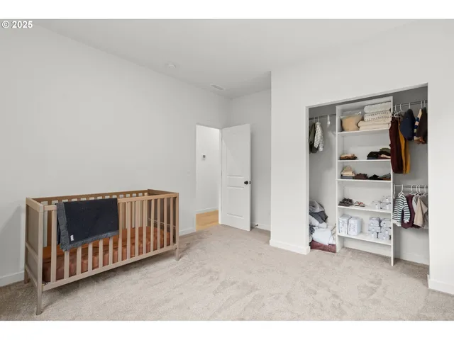 a view of a hallway with wooden floor and furniture