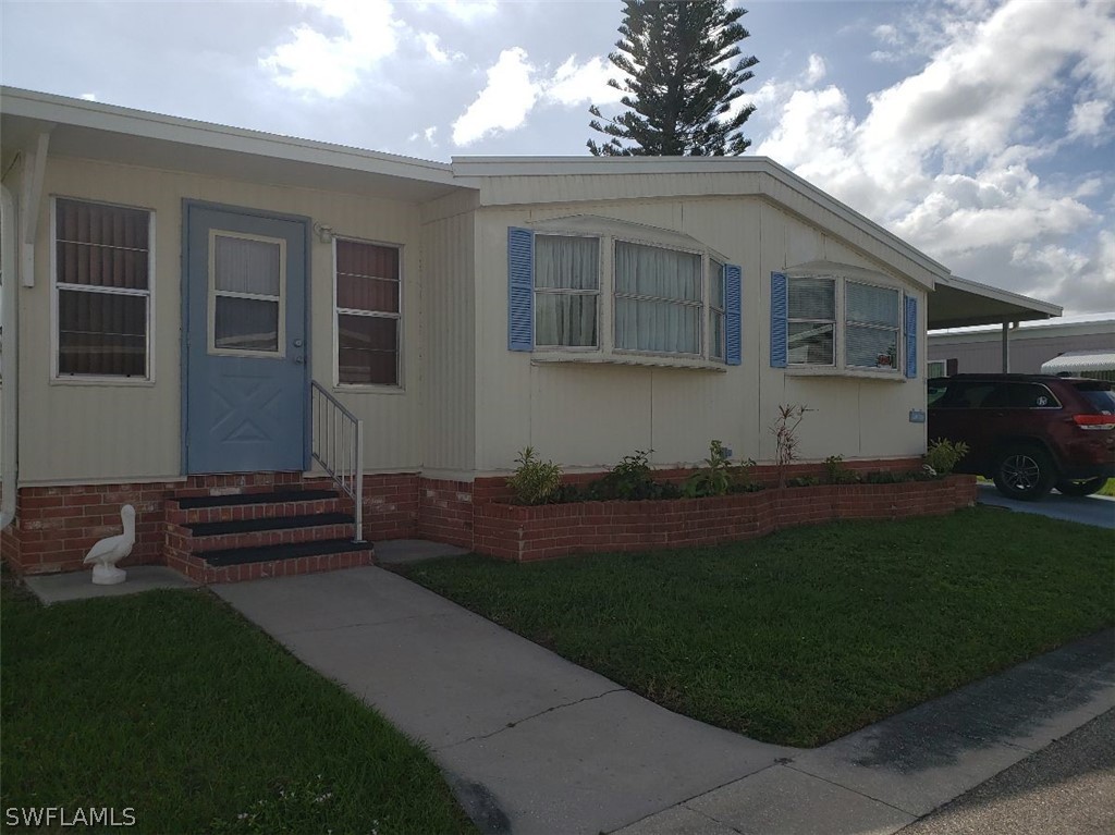 a front view of a house with a garden