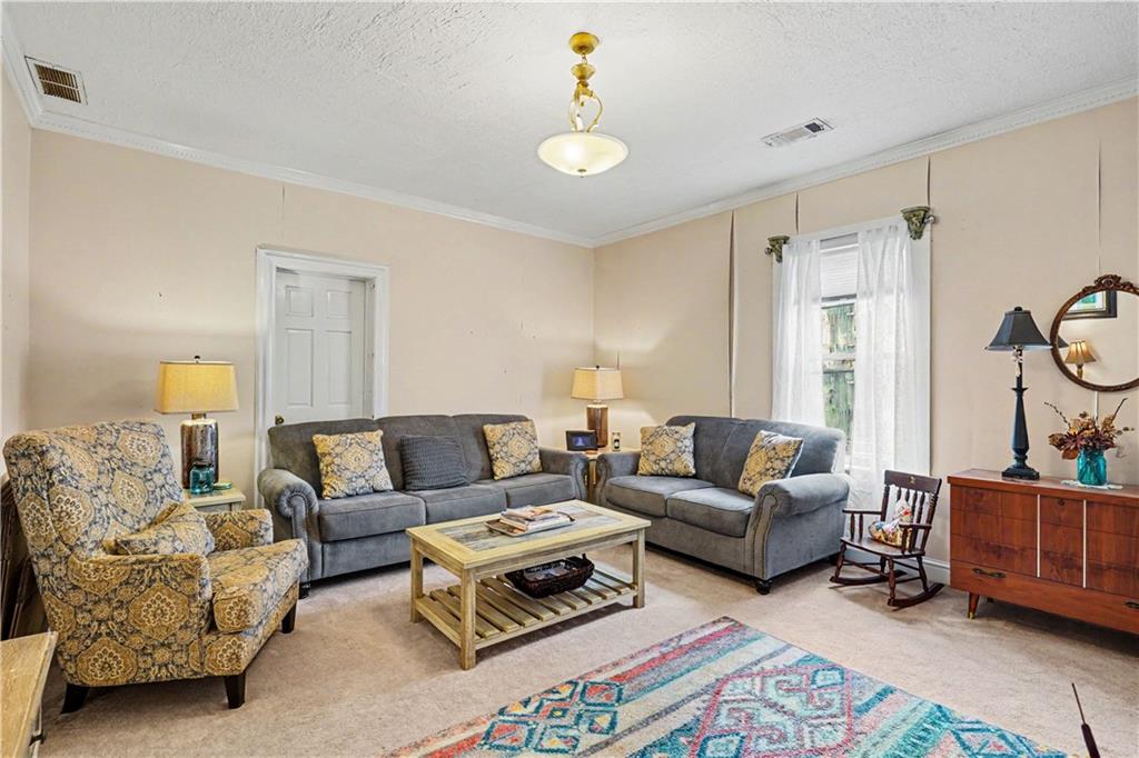 355 Inman Road Hampton, GA 30228 - Photo 8 of 47 a living room with furniture and a chandelier