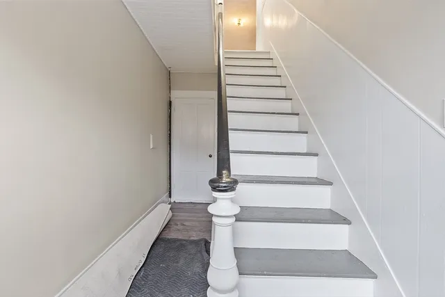 a view of entryway and hall with wooden floor