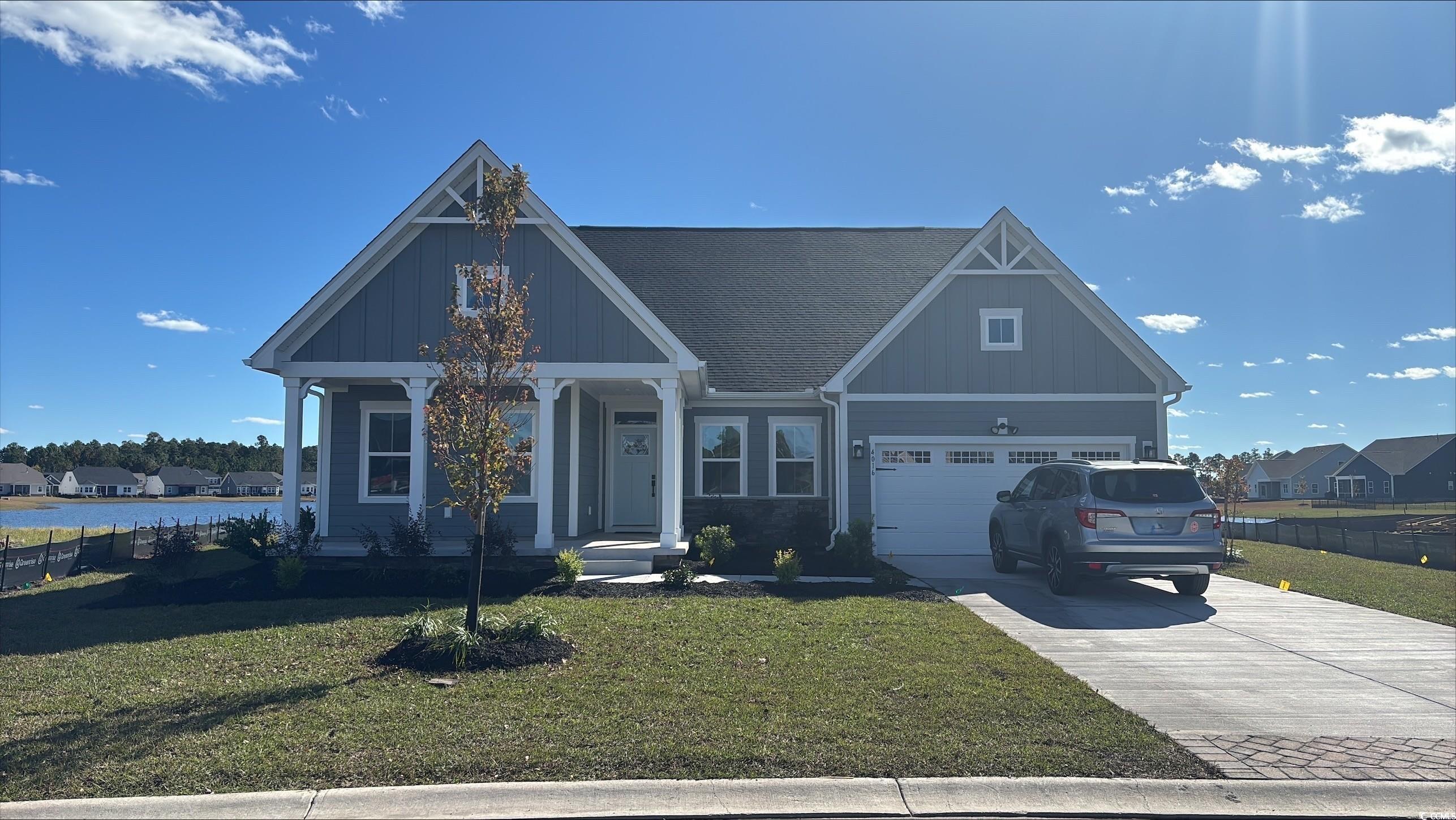 4016 Viola Loop Myrtle Beach, SC 29579 - Photo 1 of 12 Craftsman-style home featuring a front yard, driveway, a garage, and board and batten siding