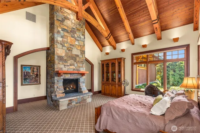 a bedroom with a bed and a fireplace