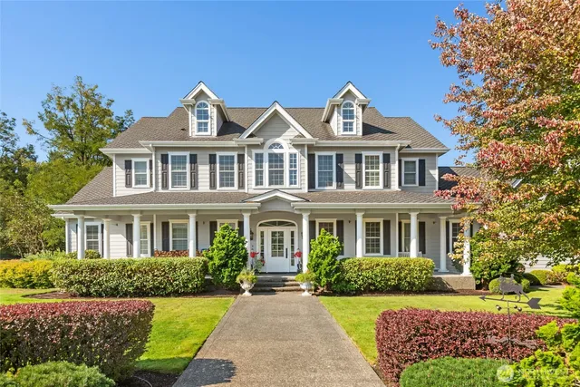 a front view of a house with a garden