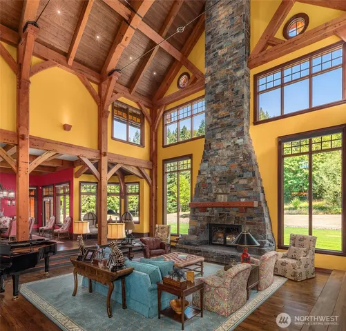 a living room with fireplace furniture and a large window