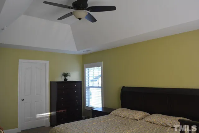 a bedroom with a bed and a dresser