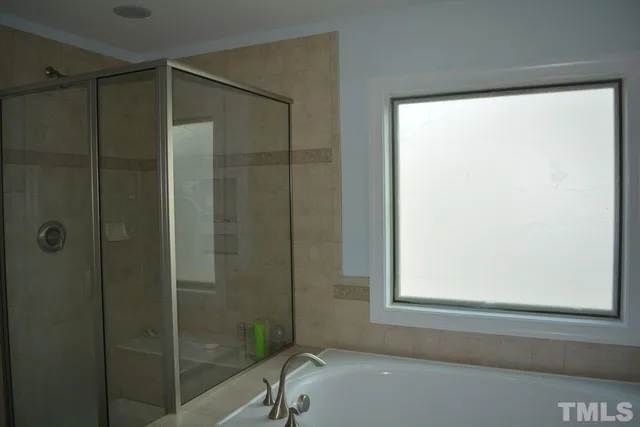 a bathroom with a shower and a window