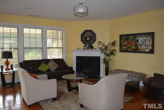 a living room with furniture a chandelier and a fireplace