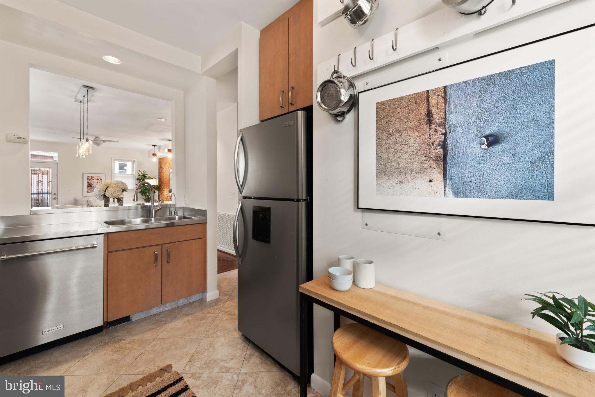 1641 V Street Northwest Washington, DC 20009 - Photo 11 of 36 a kitchen with stainless steel appliances granite countertop a refrigerator a sink and white cabinets