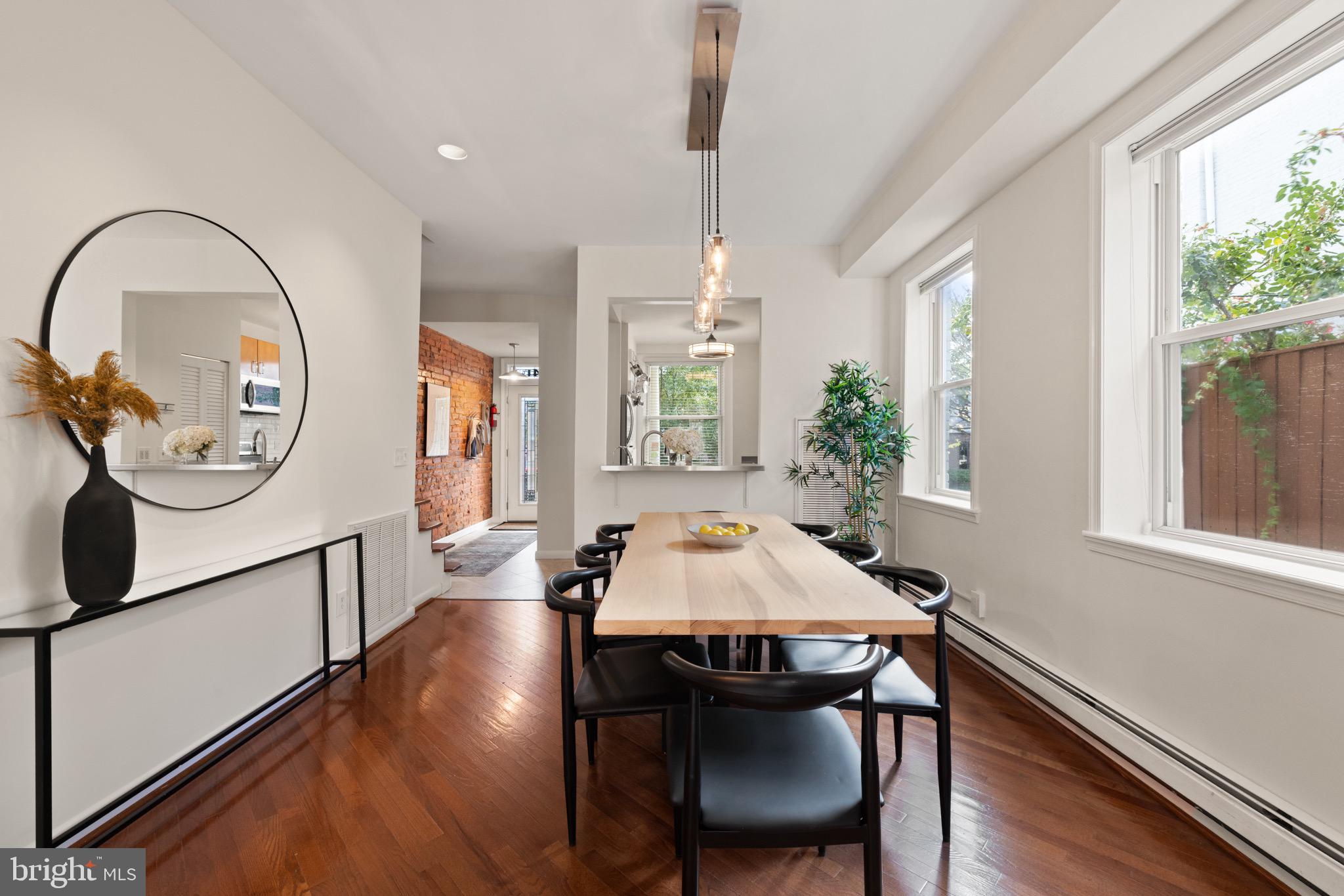 1641 V Street Northwest Washington, DC 20009 - Photo 13 of 36 a dining room with wooden floor a chandelier a wooden table and chairs