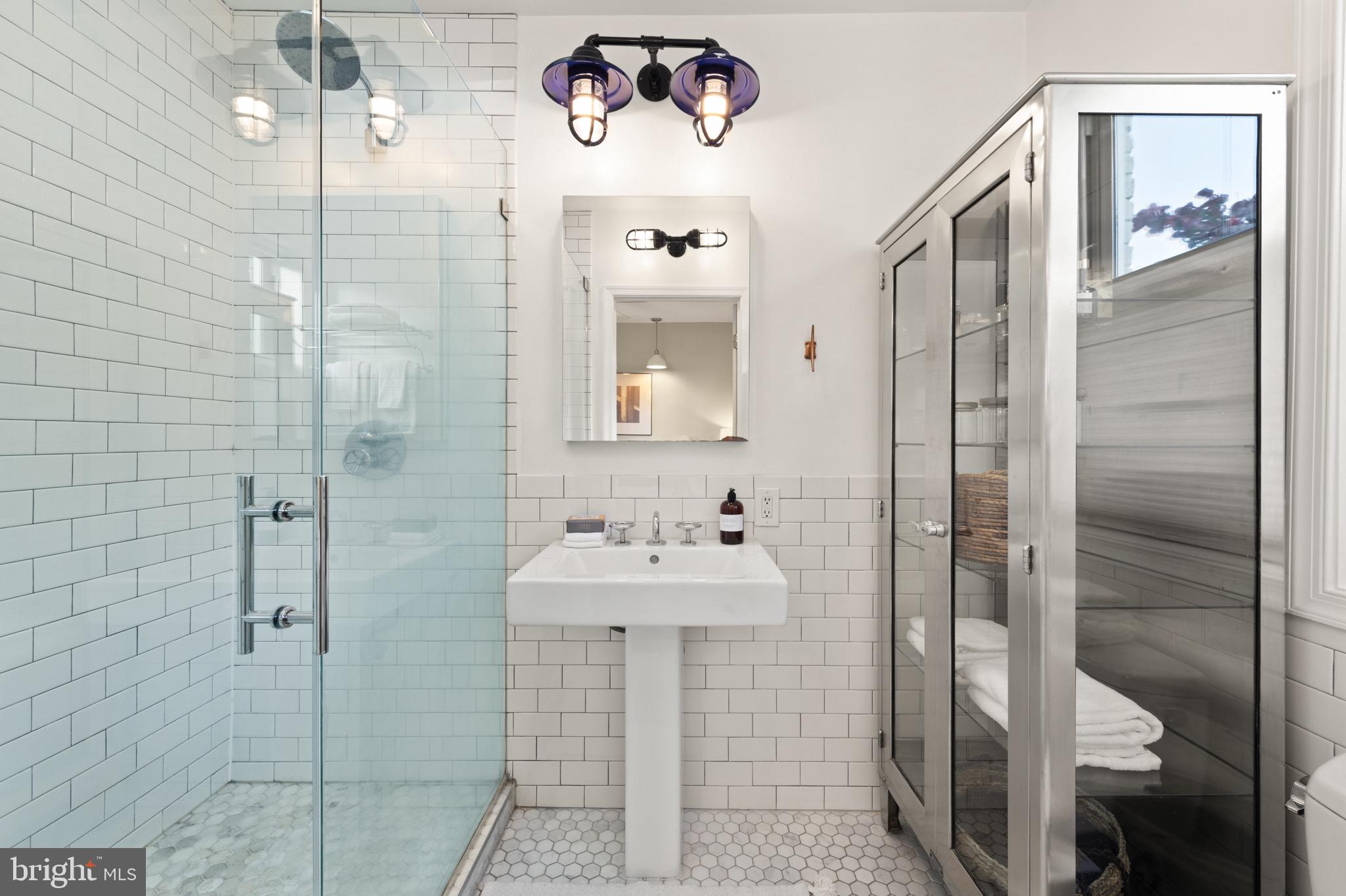 1641 V Street Northwest Washington, DC 20009 - Photo 21 of 36 a bathroom with a sink mirror and shower