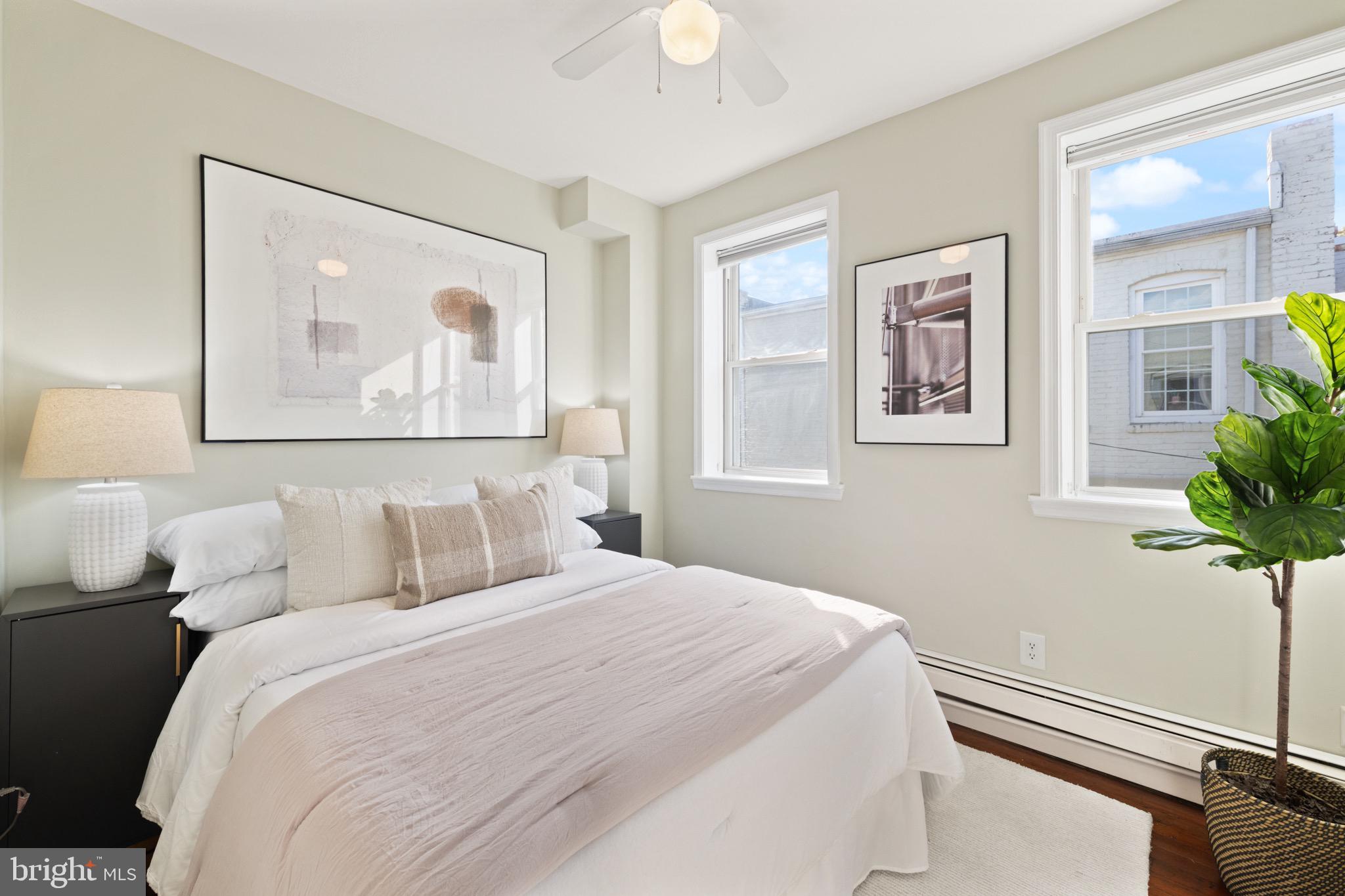 1641 V Street Northwest Washington, DC 20009 - Photo 23 of 36 a bedroom with a bed and a painting on the wall