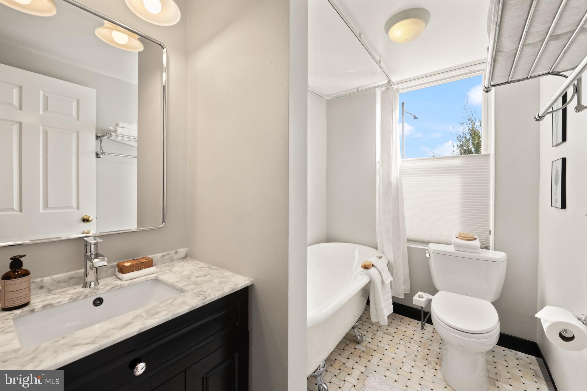 1641 V Street Northwest Washington, DC 20009 - Photo 26 of 36 a bathroom with a granite countertop sink toilet and shower