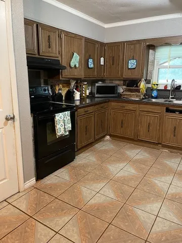 a kitchen with stainless steel appliances a stove a sink and a refrigerator