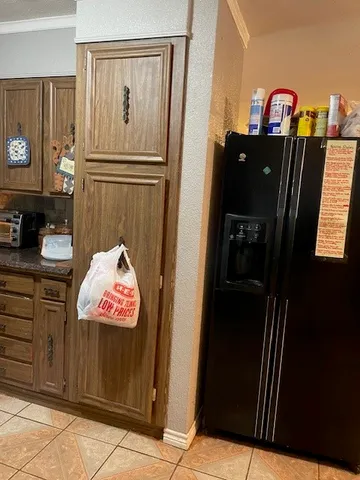 a kitchen with a refrigerator and a stove