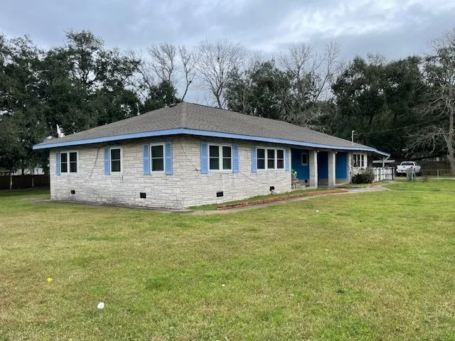 a front view of house with yard barbeque and outdoor seating