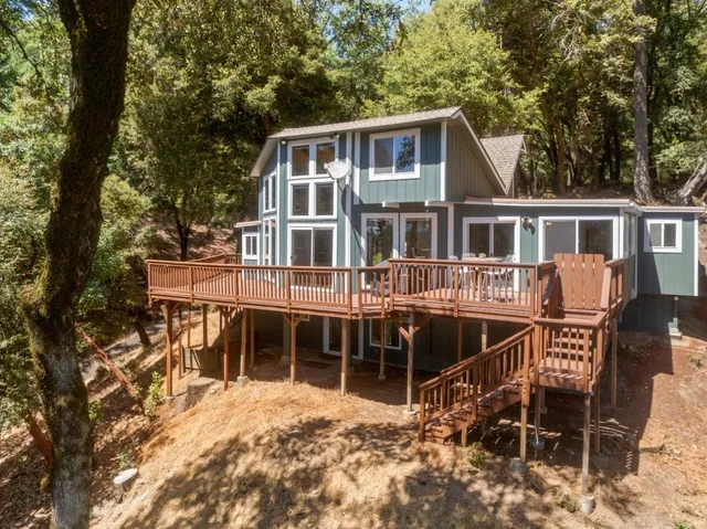 an aerial view of a house with a yard