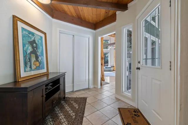 a living room with furniture and floor to ceiling windows